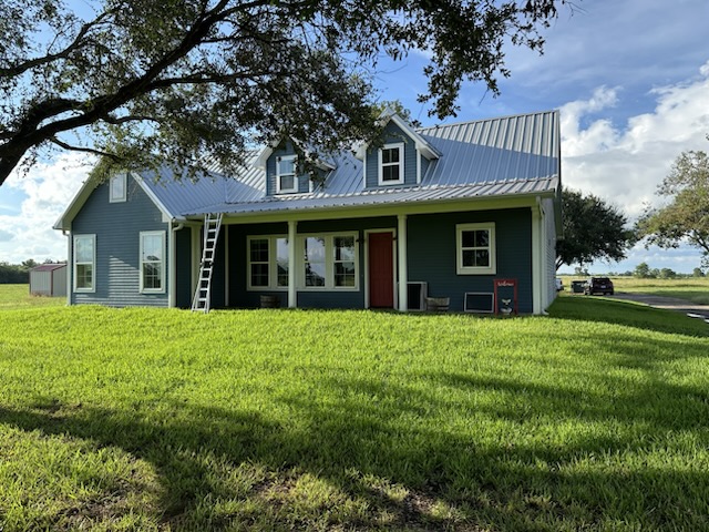 Porch windows and exterior of a blue country home