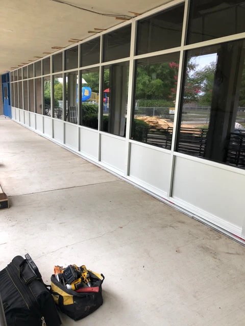 A row of commercial glass windows and doors during installation