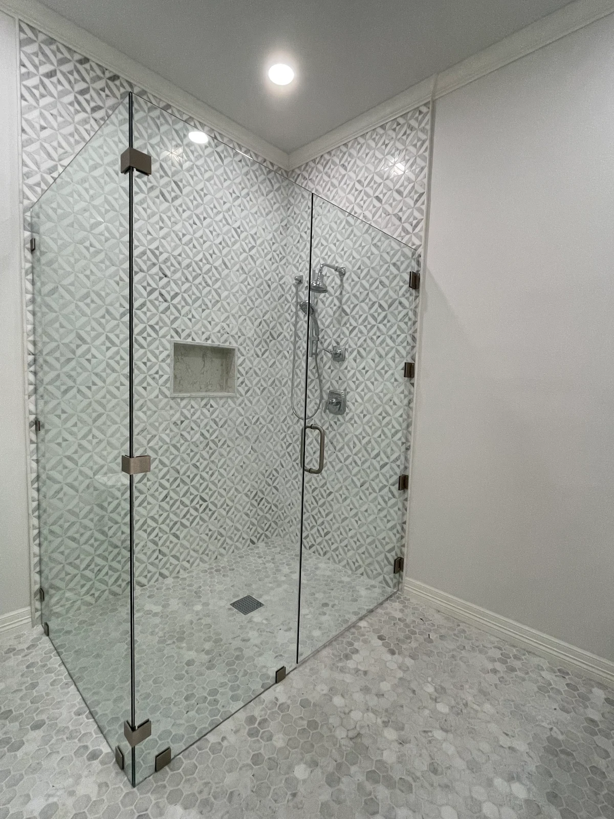 Glass project: Frameless corner shower enclosure with geometric wall tile